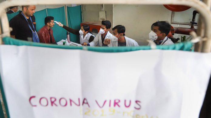 Medics screen patients as part of a precautionary measure against novel coronavirus in New Delhi | PTI Photo